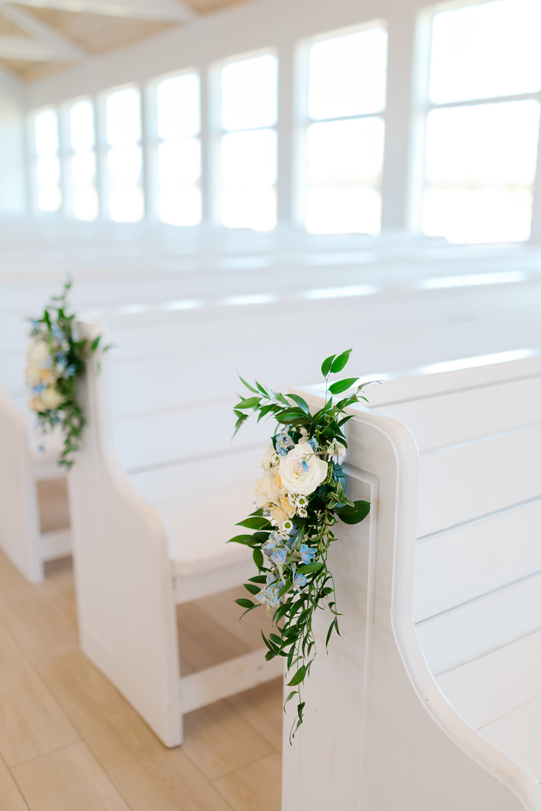 Flowers on pew at Camp Hosea wedding ceremony