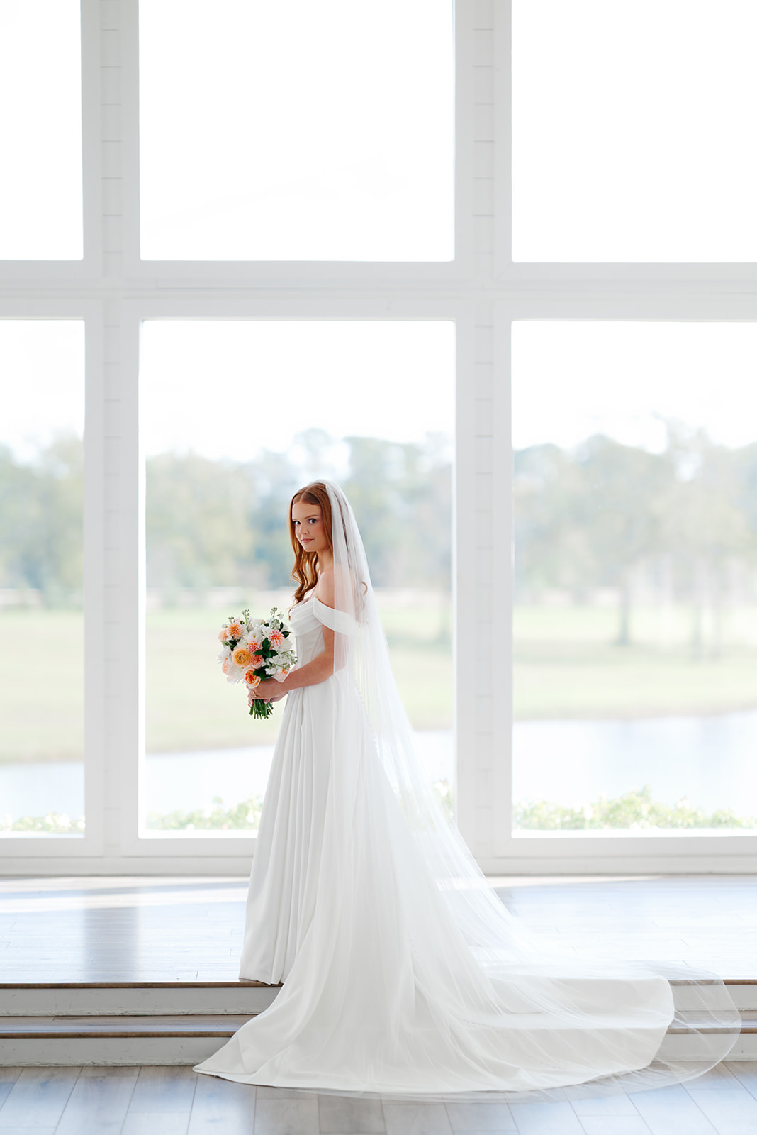 Bride in front of large windows at The Farmhouse in Texas