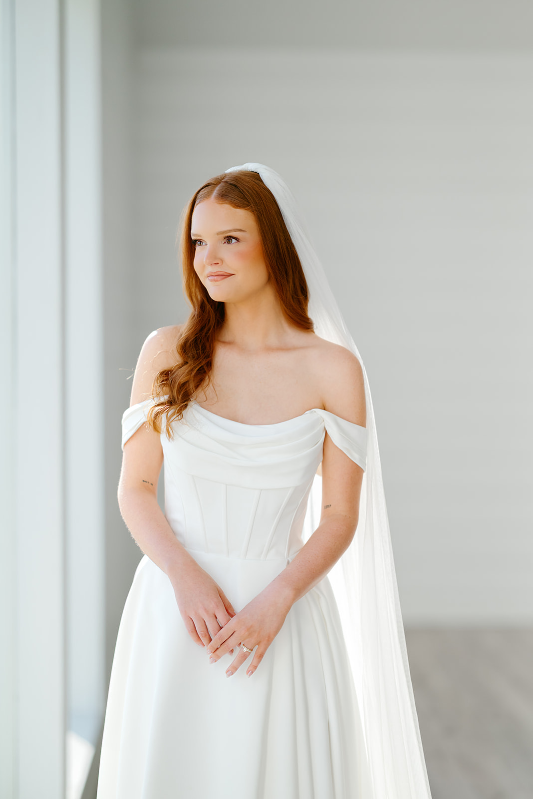 Bride looks out window at The Farmhouse in Texas