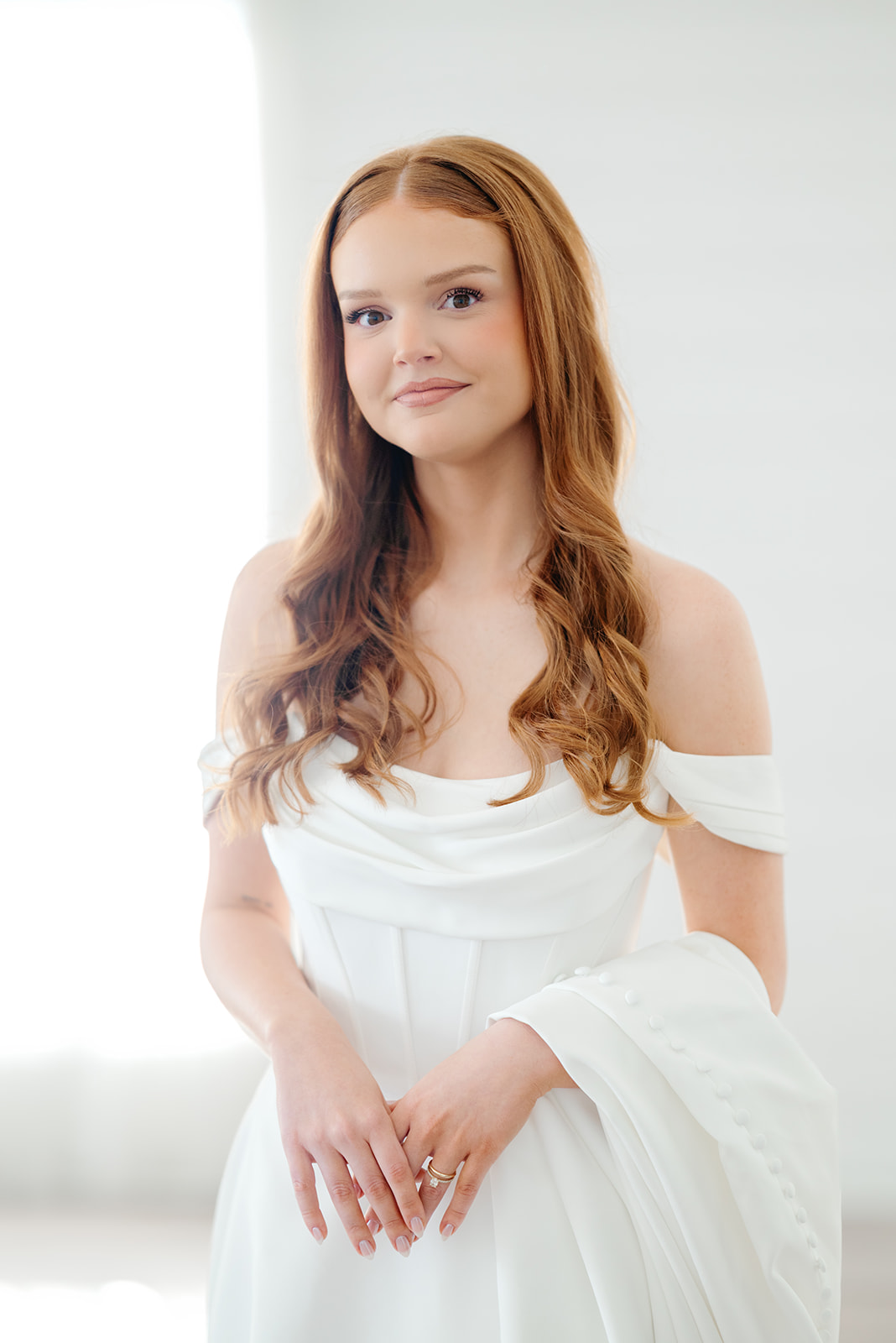 Bride with long red hair smiles at camera during Texas bridal portraits