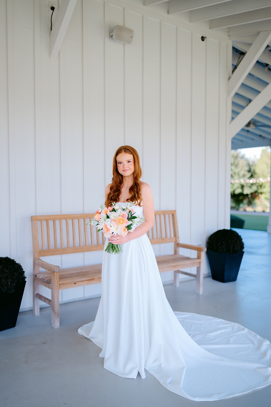 Bride stands on porch during Texas bridal portrait session