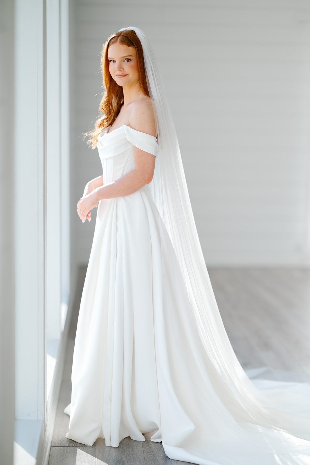 Bride in wedding dress with long veil at Texas bridal portrait session