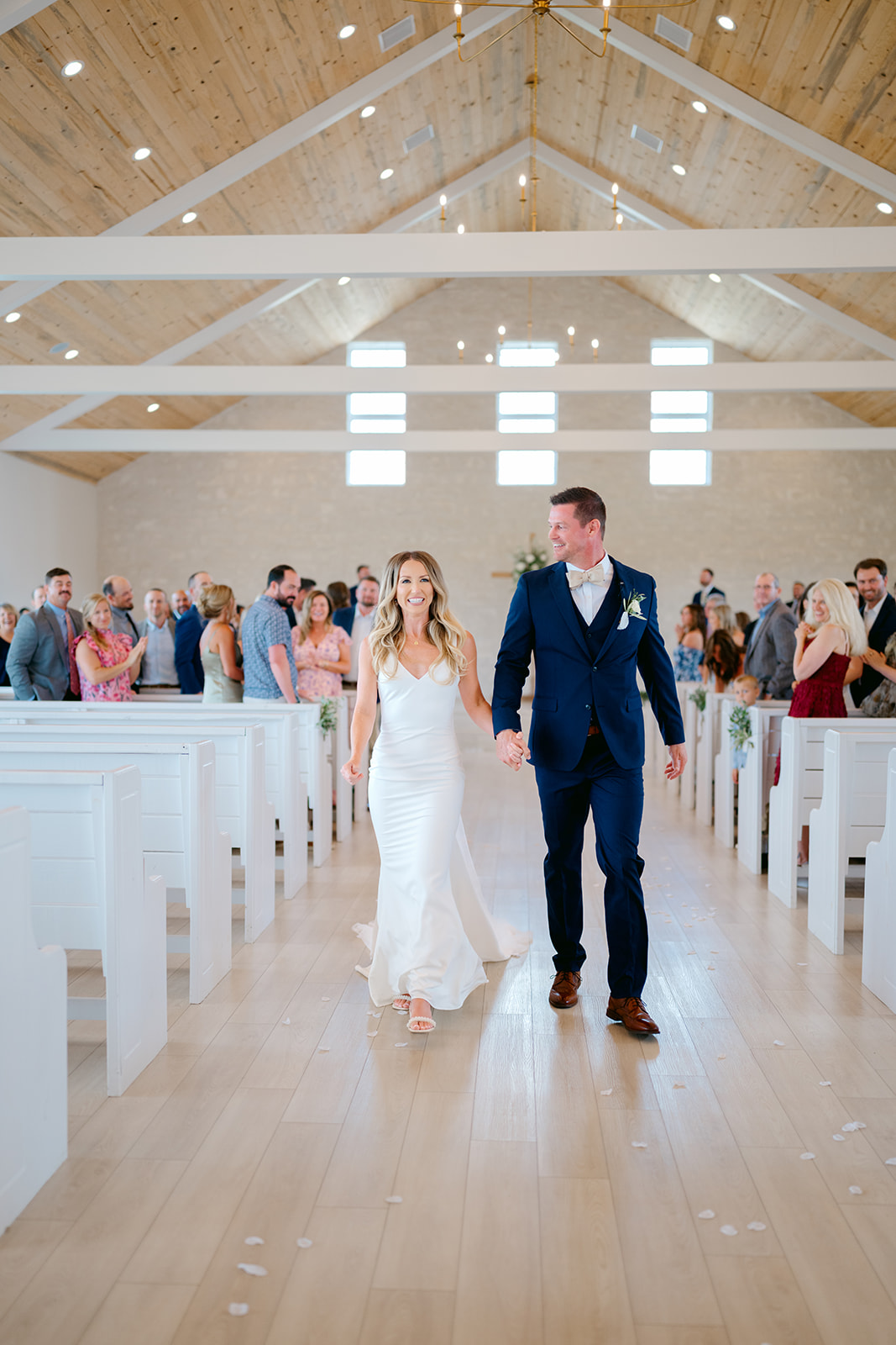 Bride and groom exit wedding ceremony, photo by second photographer