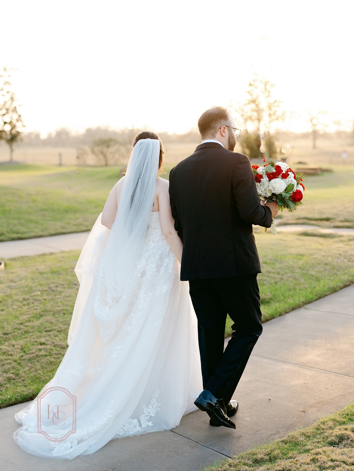 Bride and groom walk holding hands
