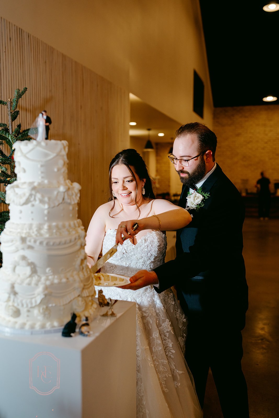Bride and groom cut 4-tier wedding cake