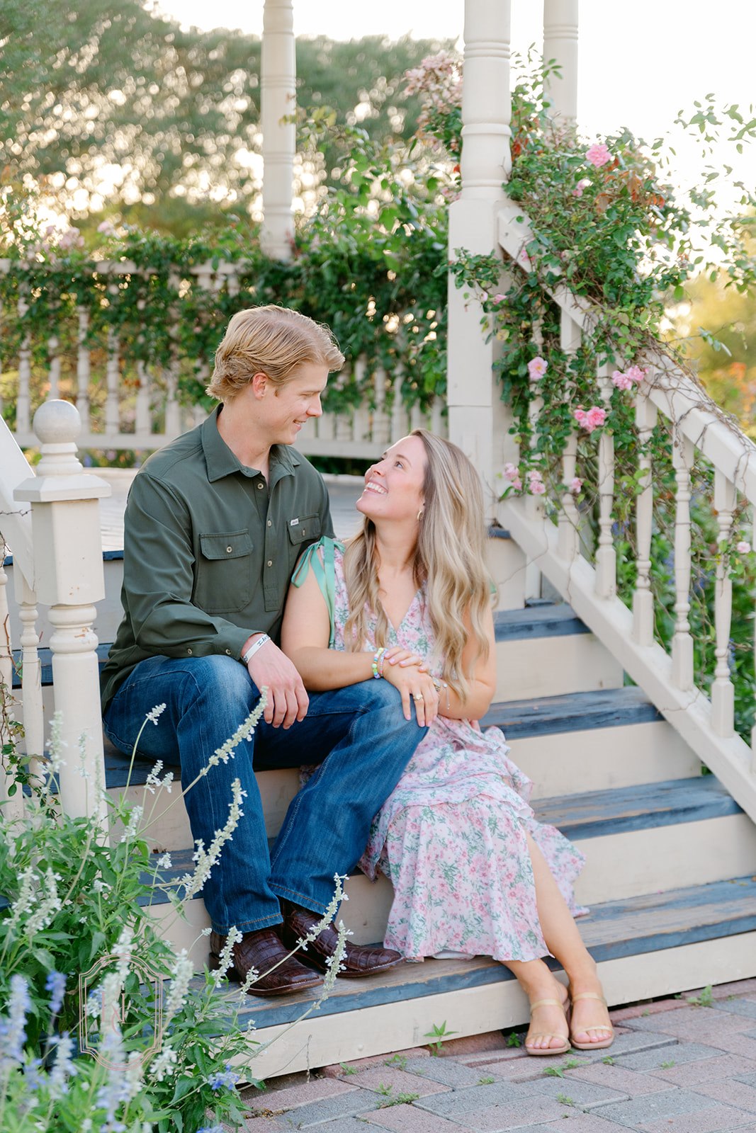 Couple smiles at each other at The Antique Rose Emporium