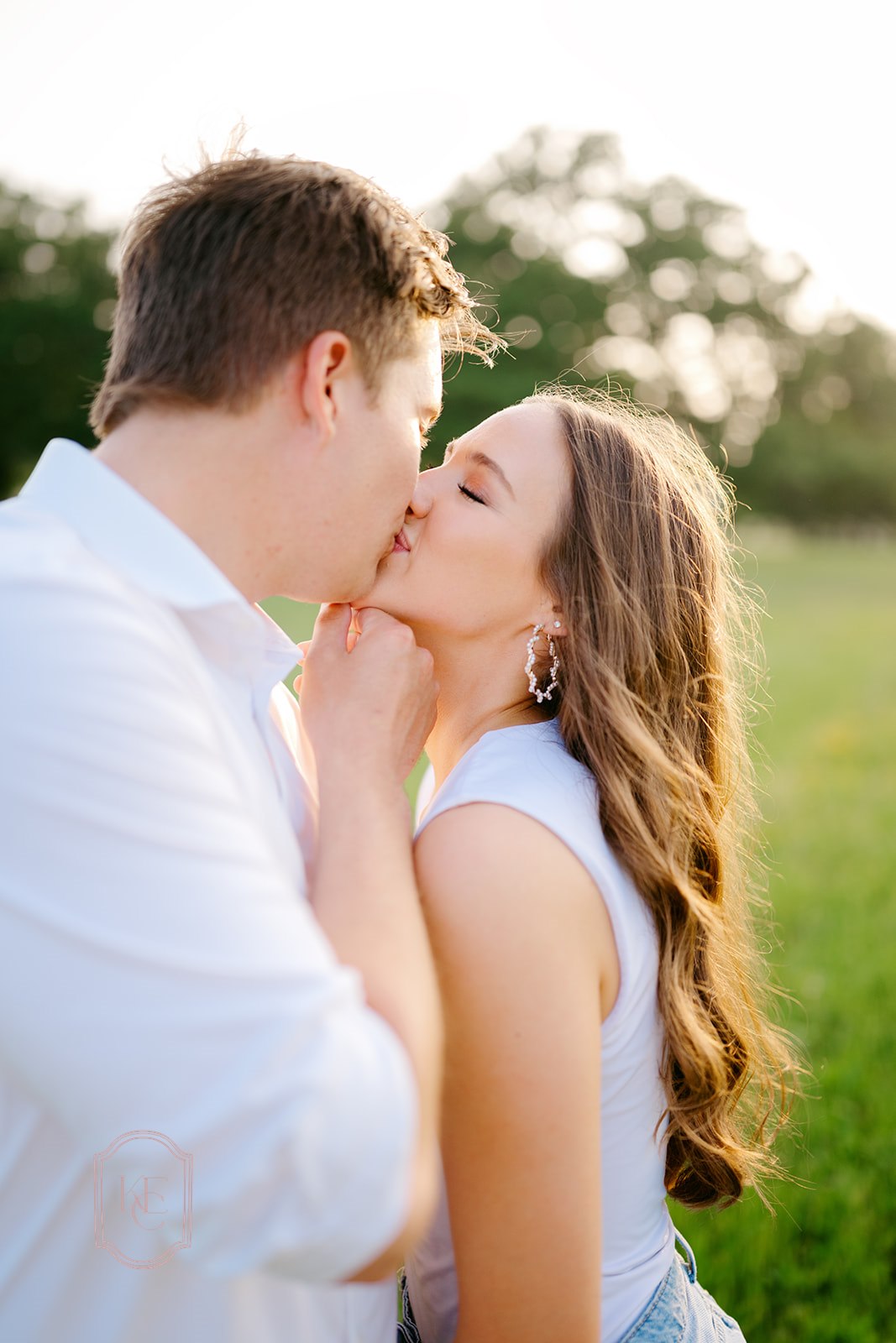 Couple kisses during their outdoor engagement photo session