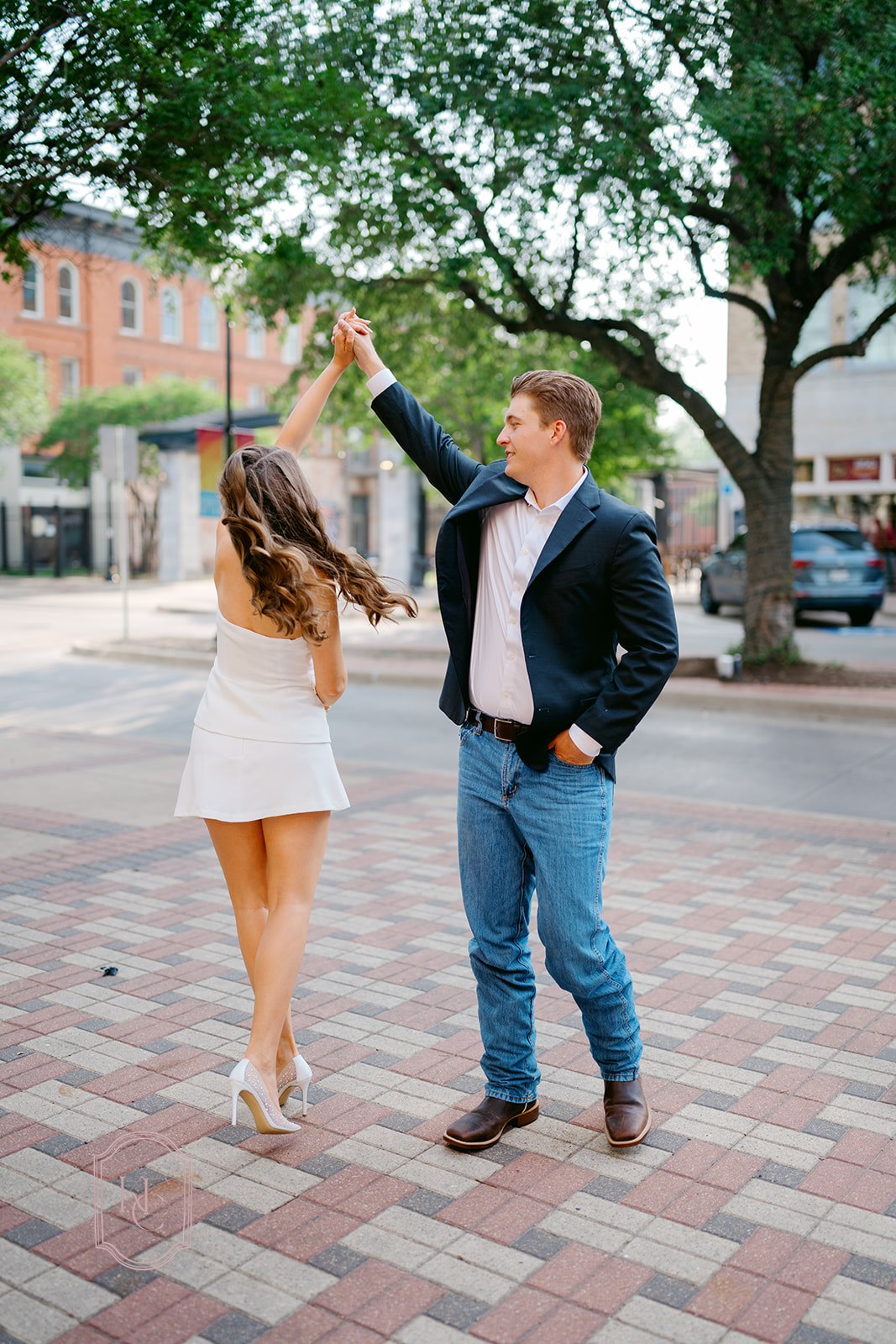 Man spins woman during outdoor engagement session
