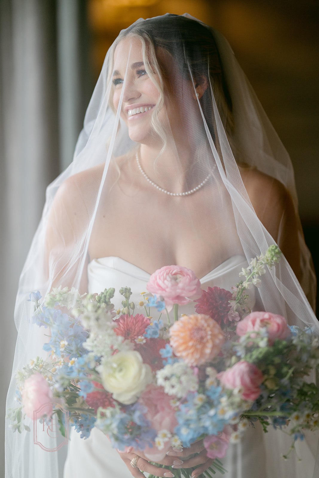 Bride wearing veil at her bridal portraits at the Weinberg at Wixon Valley